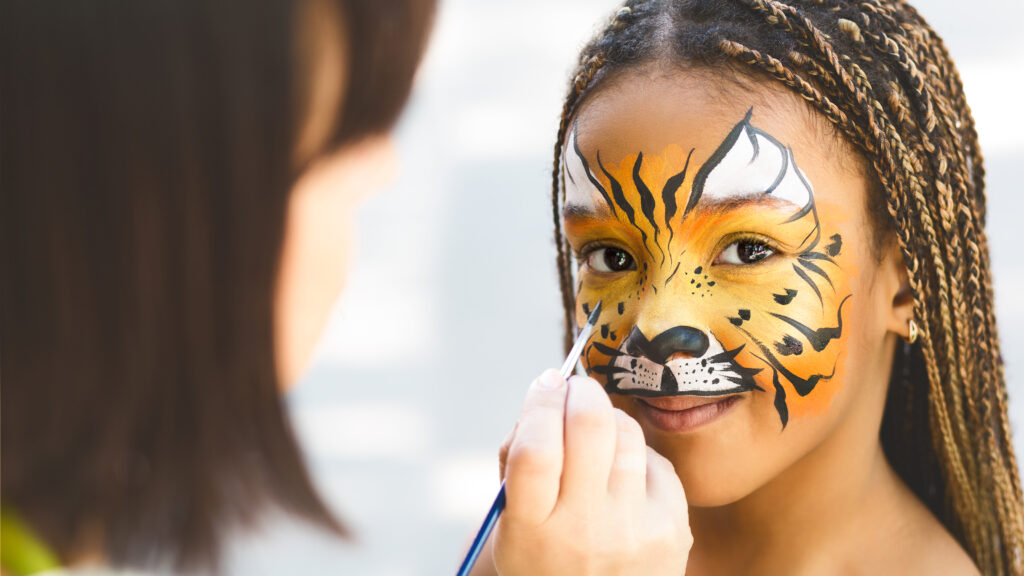 Adorable,African-american,Girl,Getting,Tiger,Face,Painting,In,Park,,Empty